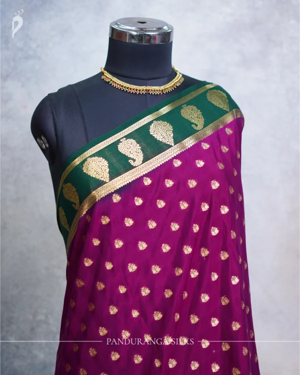 Magenta Purple Mysore Crepe Silk Saree with Golden Zari Buttas Magenta purple Mysore Crepe silk saree with golden zari buttas and bottle green floral zari border