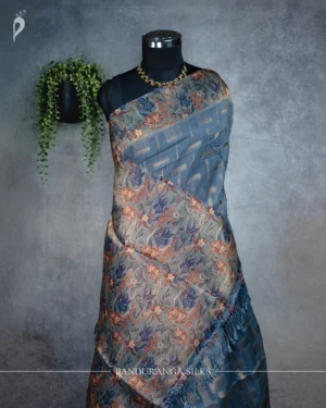 Dusty Steel Blue Tissue Silk Saree with Floral Woven Border Dusty steel blue tissue silk saree with multicolour floral weave and antique gold border