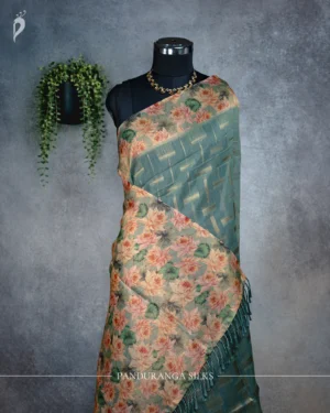 Teal blue tissue silk saree with lotus floral pallu and antique gold woven detailing