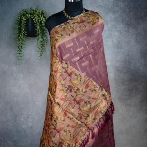 Dusty rose tissue silk saree with multicolour floral pallu, gold detailing and maroon tassels