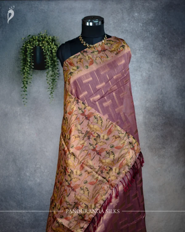 Dusty Rose Tissue Silk Saree with Floral Pallu & Gold Border Dusty rose tissue silk saree with multicolour floral pallu, gold detailing and maroon tassels