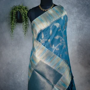 Teal blue tissue silk saree with antique gold floral weave and multicolour artistic border