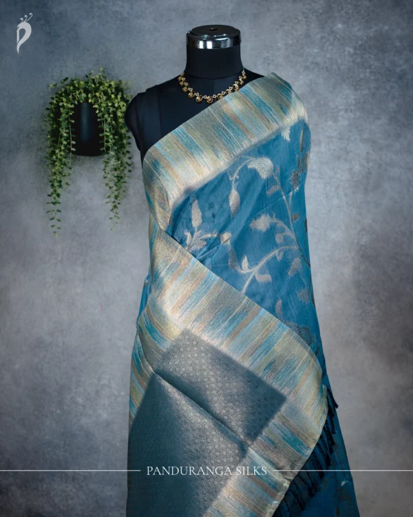 Teal Blue Tissue Silk Saree with Multicolour Artistic Border Teal blue tissue silk saree with antique gold floral weave and multicolour artistic border