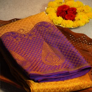 Mustard yellow handloom silk saree with royal blue-purple floral zari border, paisley pallu and matching blouse