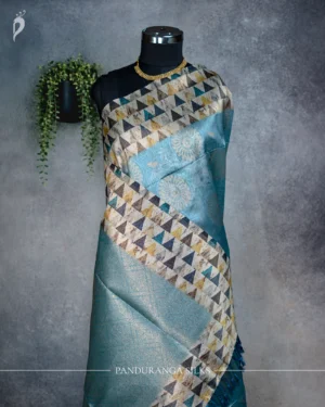 Sky blue tissue silk saree with multicolour geometric border, golden floral pallu and tassels