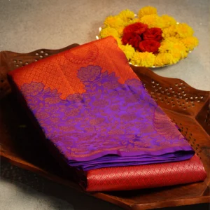 Coral pink pure silk saree with royal purple floral border, paisley buttas and traditional woven pallu