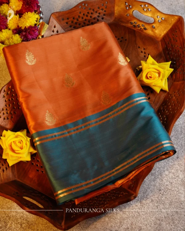 Peach Pink Gadwal Silk Saree with Gold Zari Gap Border Design Peach pink Gadwal silk saree with gold zari buttas, turquoise blue gap border and geometric zari pallu