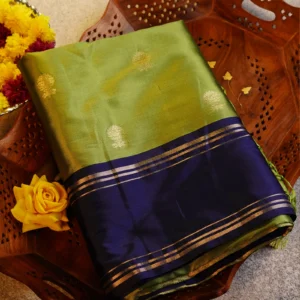 Pista green Gadwal silk saree with gold zari buttas, navy blue gap border and geometric jaal pallu