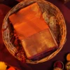 Burnt Orange Silk Saree with Zari Checks and Pineapple Buttas Burnt orange silk saree with zari checks, pineapple buttas, rich golden zari border and traditional pallu.