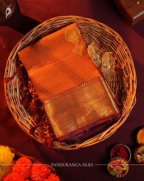 Burnt Orange Silk Saree with Zari Checks and Pineapple Buttas Burnt orange silk saree with zari checks, pineapple buttas, rich golden zari border and traditional pallu.
