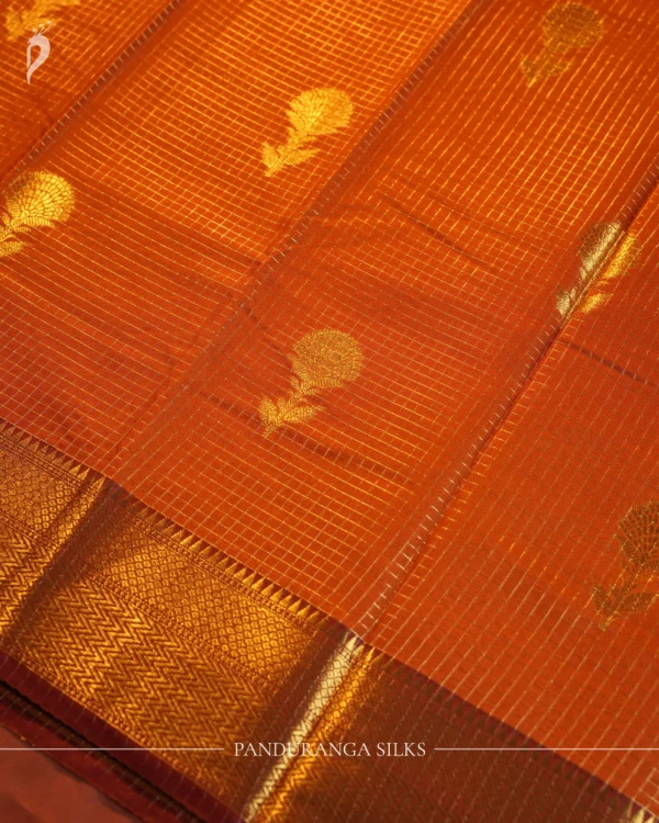 Burnt Orange Silk Saree with Zari Checks and Pineapple Buttas Burnt orange silk saree with zari checks, pineapple buttas, rich golden zari border and traditional pallu.