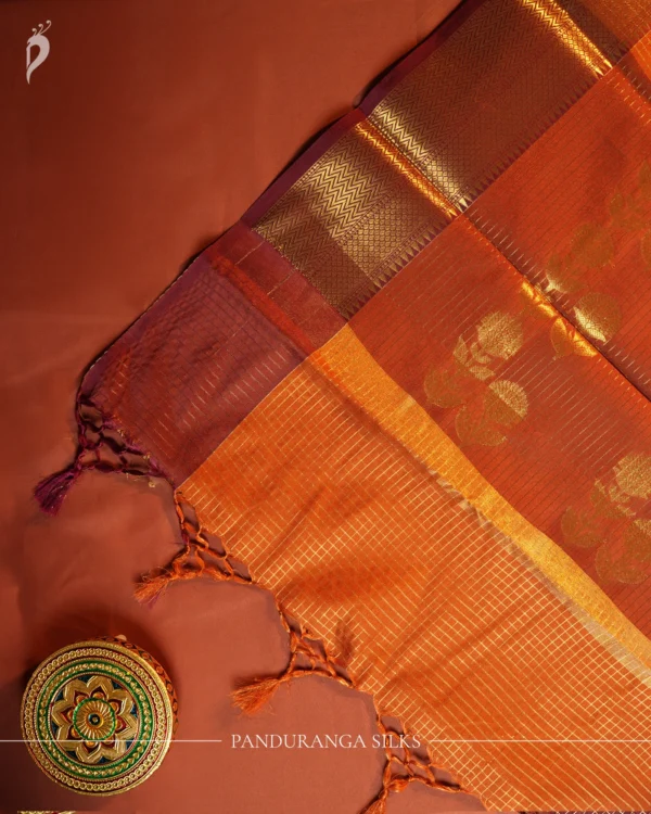 Burnt Orange Silk Saree with Zari Checks and Pineapple Buttas Burnt orange silk saree with zari checks, pineapple buttas, rich golden zari border and traditional pallu.