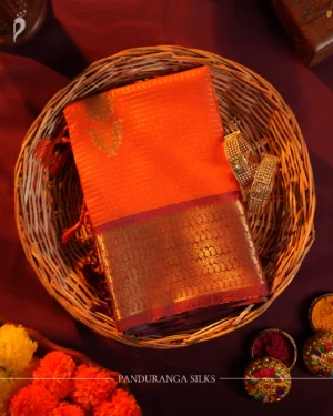 Orange silk saree with golden zari checks, pineapple motifs and woven zari border