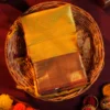 Mustard yellow silk saree with golden zari checks, pineapple motifs and geometric zari border