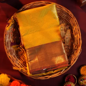 Mustard yellow silk saree with golden zari checks, pineapple motifs and geometric zari border