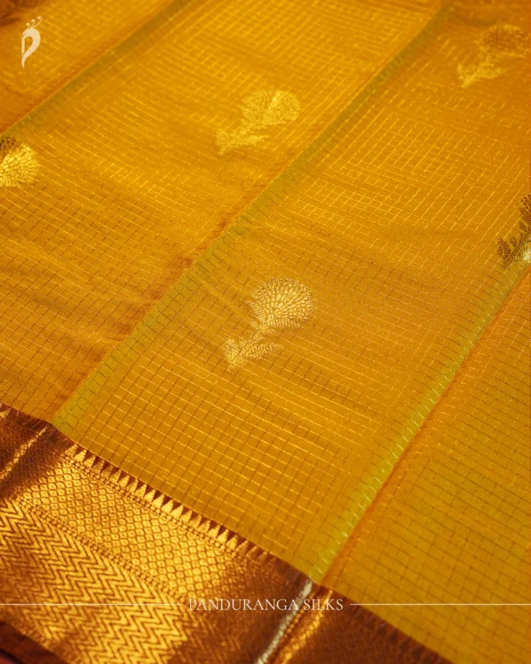 Mustard yellow silk saree with golden zari checks, pineapple motifs and geometric zari border