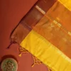 Mustard yellow silk saree with golden zari checks, pineapple motifs and geometric zari border