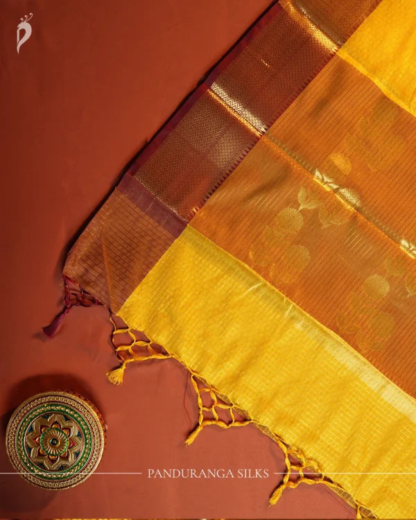 Mustard yellow silk saree with golden zari checks, pineapple motifs and geometric zari border