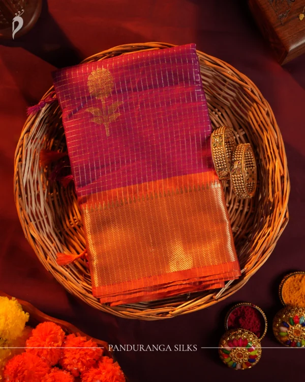 Plum Purple Silk Saree with Zari Checks and Golden Pineapple Buttas Plum purple silk saree with copper zari checks, golden pineapple motifs and geometric zari border