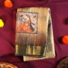Sage Green Art Silk Saree with Mughal Art and Floral Emboss Work Sage green silk saree with Mughal-inspired printed panels, floral emboss work and zari border