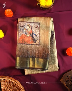 Sage Green Art Silk Saree with Mughal Art and Floral Emboss Work Sage green silk saree with Mughal-inspired printed panels, floral emboss work and zari border