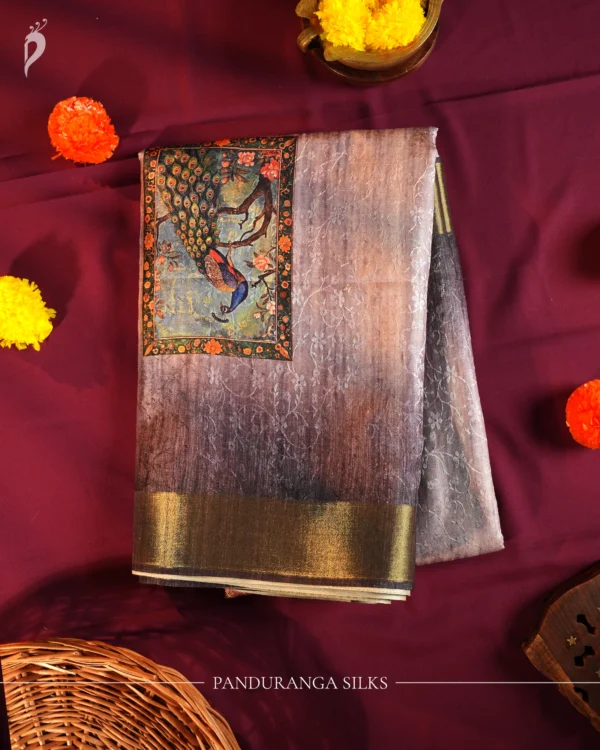 Lavender Grey Silk Saree with Mughal Art and Floral Emboss Work Lavender grey silk saree with Mughal-inspired peacock panels, floral emboss work and zari border