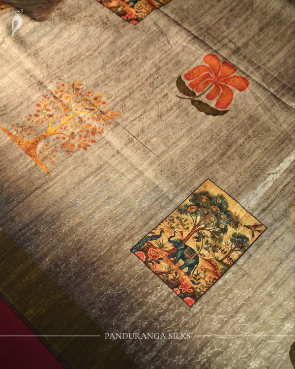 Steel grey silk saree with Mughal-inspired elephant art, floral emboss work and subtle zari border