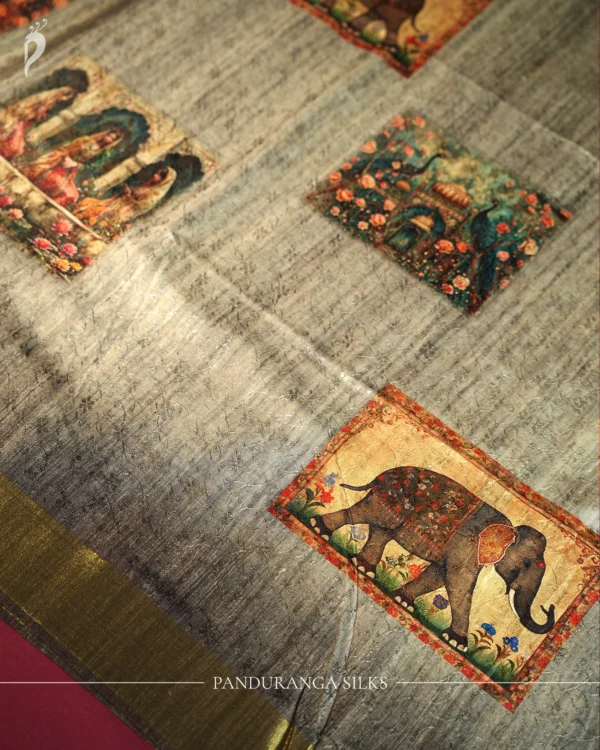 Charcoal Grey Silk Saree with Mughal Prints and Floral Emboss Work Charcoal grey silk saree with Mughal-inspired art, floral emboss work, multicolour panels and zari border