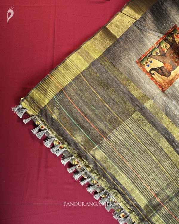 Charcoal Grey Silk Saree with Mughal Prints and Floral Emboss Work Charcoal grey silk saree with Mughal-inspired art, floral emboss work, multicolour panels and zari border