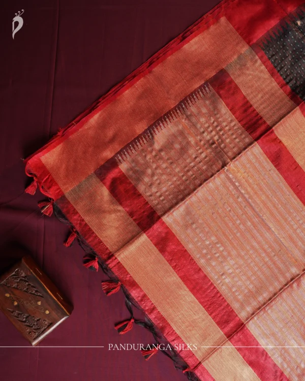 Charcoal Black Raw Silk Saree with Checked Design and Maroon Border Charcoal black raw silk saree with zari checks, maroon temple-work border, contrast pallu and tassels