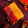 Mustard Yellow Raw Silk Saree with Checks and Wine Maroon Border Mustard yellow raw silk saree with zari checks, wine maroon temple border and contrasting zari-woven pallu