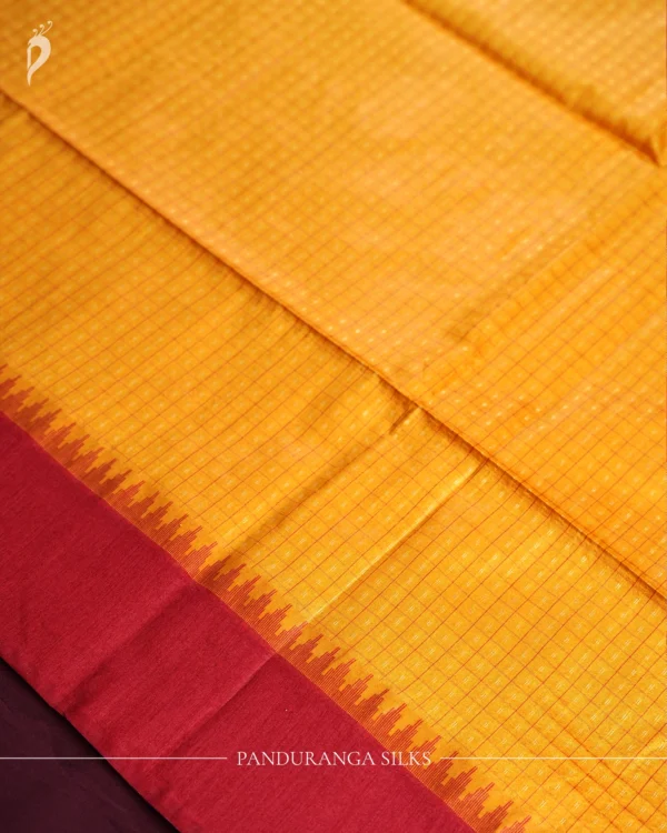 Mustard Yellow Raw Silk Saree with Checks and Wine Maroon Border Mustard yellow raw silk saree with zari checks, wine maroon temple border and contrasting zari-woven pallu