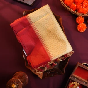 Ivory raw silk saree with zari checks, deep maroon temple border, contrasting pallu and tassel detailing