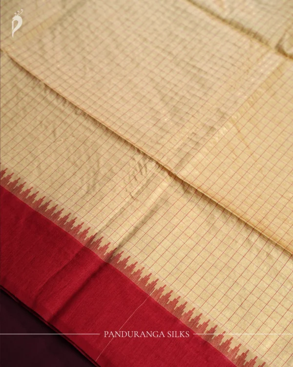 Ivory Raw Silk Saree with Checks and Deep Maroon Temple Border Ivory raw silk saree with zari checks, deep maroon temple border, contrasting pallu and tassel detailing