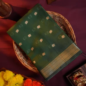 Green silk cotton saree with golden zari buttas and a traditional design