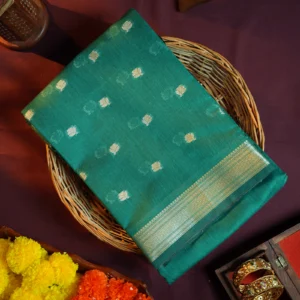 Peacock blue silk cotton saree with golden zari buttas and sage grey pallu