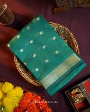 Peacock blue silk cotton saree with golden zari buttas and sage grey pallu