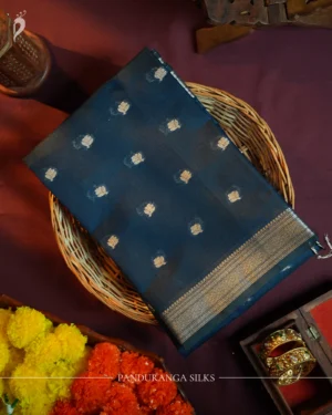 Navy blue silk cotton saree with golden zari buttas and sage grey pallu