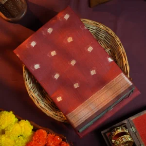 Maroon silk cotton saree with golden zari buttas and sage grey pallu