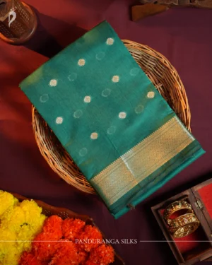 Peacock blue silk cotton saree with golden zari buttas and sage grey pallu and blouse