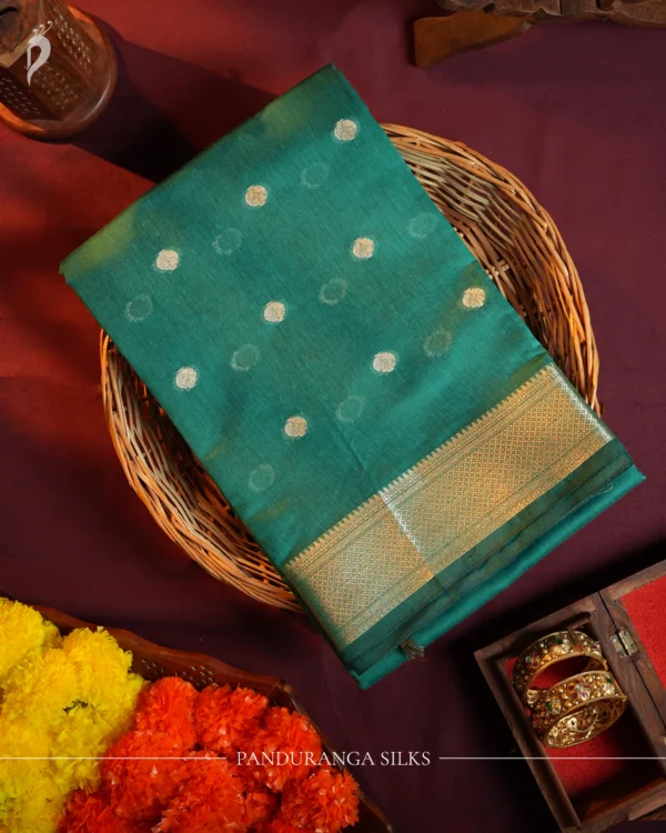 Peacock Blue Soft Silk Cotton Saree with Beautiful Golden Zari Buttas Peacock blue silk cotton saree with golden zari buttas and sage grey pallu and blouse