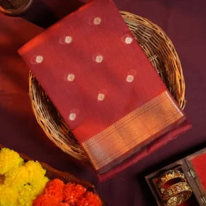 Maroon silk cotton saree with golden zari buttas and sage grey pallu and blouse