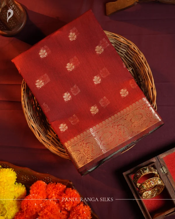 Red silk cotton saree with golden zari buttas and sage grey pallu and blouse