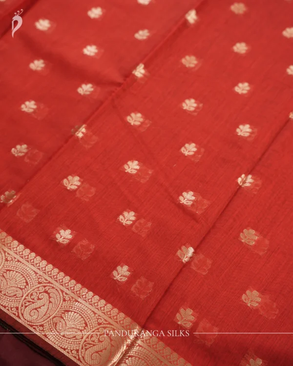 Red silk cotton saree with golden zari buttas and sage grey pallu and blouse