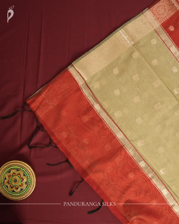 Red silk cotton saree with golden zari buttas and sage grey pallu and blouse