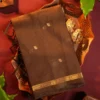 Brown Soft Silk Cotton Saree with Golden Zari Buttas and Purple Pallu Brown silk cotton saree with golden zari buttas and a purple pallu with zari border