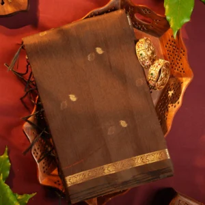 Brown silk cotton saree with golden zari buttas and a purple pallu with zari border