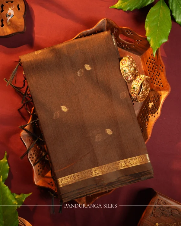 Brown Soft Silk Cotton Saree with Golden Zari Buttas and Purple Pallu Brown silk cotton saree with golden zari buttas and a purple pallu with zari border