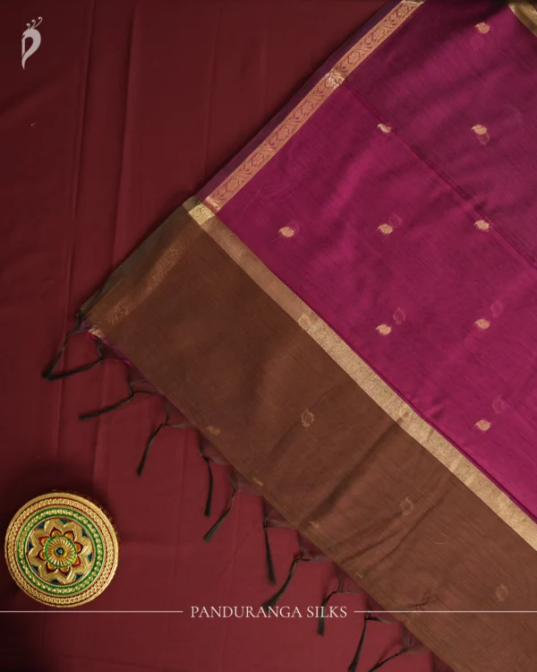 Brown Soft Silk Cotton Saree with Golden Zari Buttas and Purple Pallu Brown silk cotton saree with golden zari buttas and a purple pallu with zari border