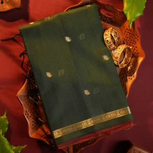 Dark green silk cotton saree with golden zari buttas and detailed zari border